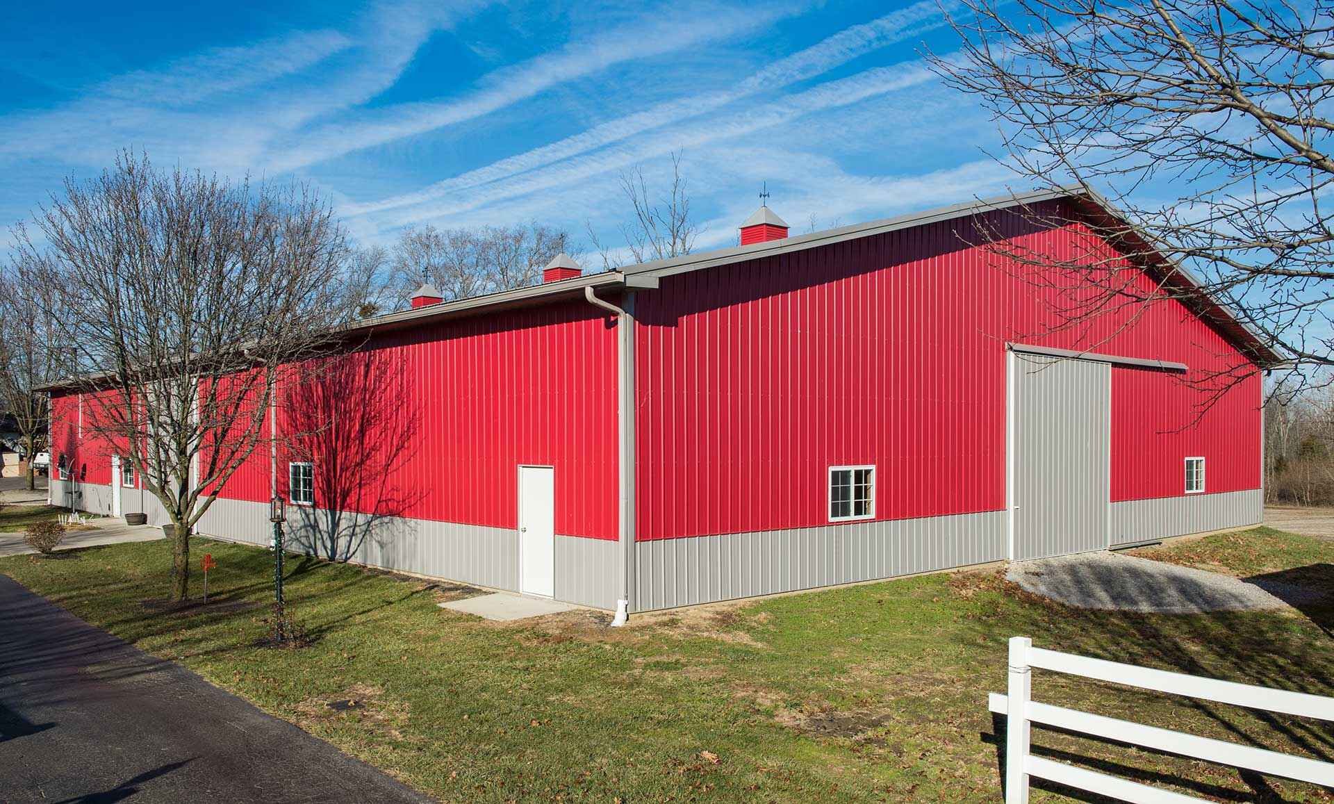 Red metal building exterior beneath a bright blue sky